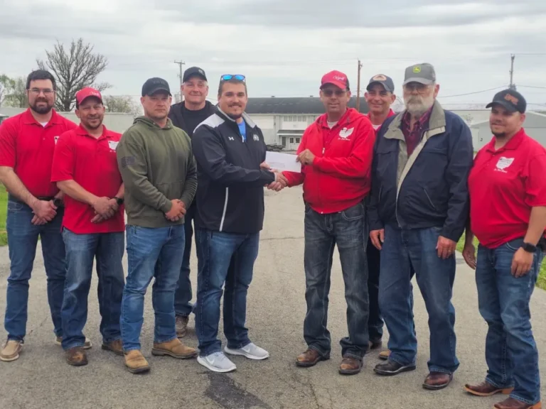 Wyandot county fair board president Nick Derr presents a donation check to the Hardin County fair board for tornado damage relief.